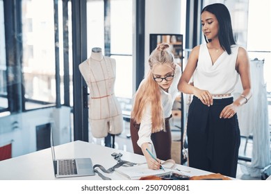 Women, fashion designer and writing with measuring tape for size at workshop or boutique store. Young, female person or tailors checking measurement on body for clothing line, style or production - Powered by Shutterstock