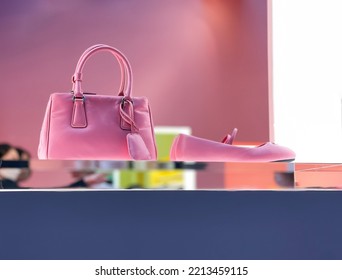 Women Fashion Pink Handbag With Shoes Display On Shelf