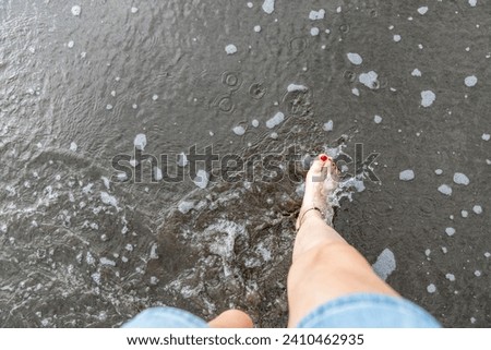 Women feet in the beach in the sand top view water ocean sand