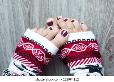 Women Feet With Pedicure In A Christmas Socks