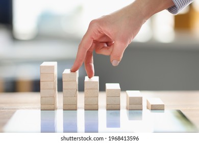 Women Fingers Climb Up Wooden Block Closeup