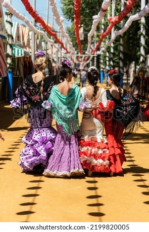 Women in flamenco dresses during fair in city