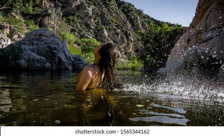 Women Flipping Hair In Mojave River At The Deep Creek Hot Springs In California, USA