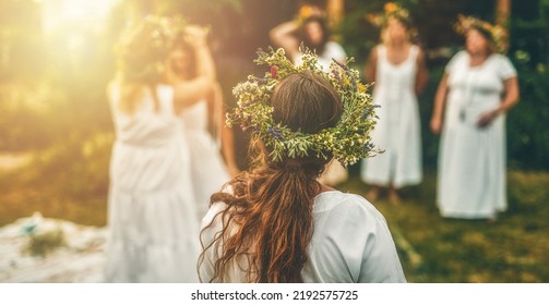 Women in flower wreath on sunny meadow, Floral crown, symbol of summer solstice. - Shutterstock ID 2192575725