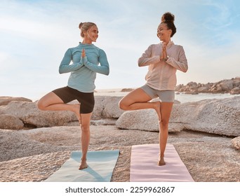 Women friends, beach yoga and smile in morning with stretching legs for health, wellness and training. Black woman, exercise group and motivation for teamwork with balance, peace and support by sea - Powered by Shutterstock