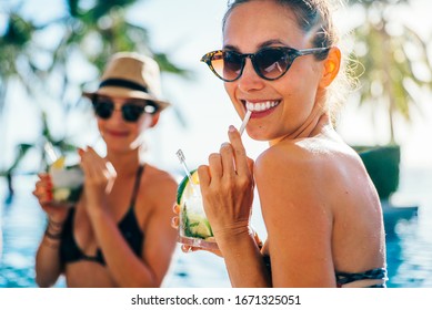 Women Friends Drink, Cocktail Mojito On Pool Bar, Wear Bikini Luxury Hotel Near Beach On Tropical Island Relax
