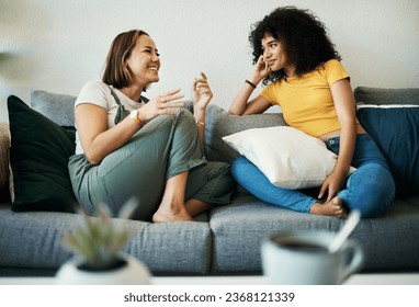 Women, friends relax and conversation in a home with gossip, discussion and happy in a living room. Couch, smile and female person on sofa with communication together in a house lounge with speaking - Powered by Shutterstock