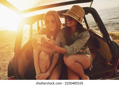 Women friends, selfie and car on road trip, beach and happy for social media app with smile on holiday. Woman, smartphone and happy friendship, ocean vacation or sunglasses for summer sunshine on web - Powered by Shutterstock