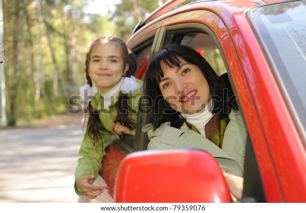 women and girl in\
auto