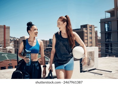 Women go to sports training with ball, rooftop city sports in Colombia or walking to football game. Friends exercise together, happy to exercise in urban lifestyle or healthy soccer coach workout - Powered by Shutterstock