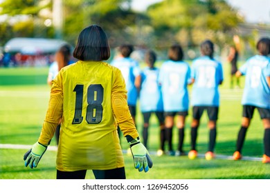 Women Goal Keeper Standing On Field For Protect Other Player Team Shoot Ball To Goal. 