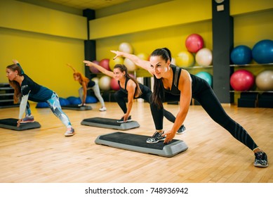 Women group on step aerobic training