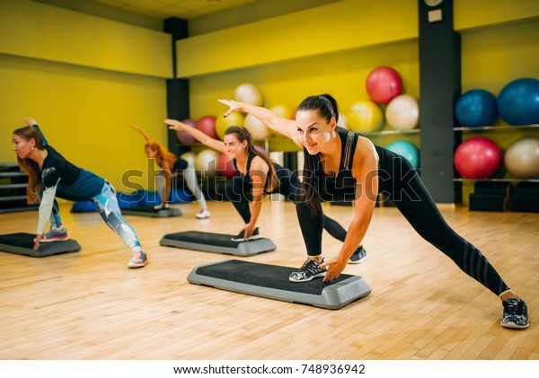 Women group on step\
aerobic training