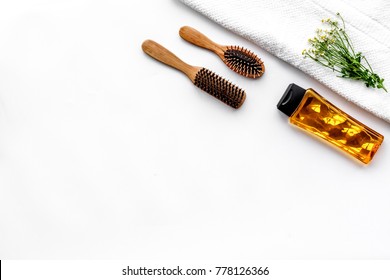 Women Hair Care Set. Combs And Shampoo On White Background Top View Copyspace