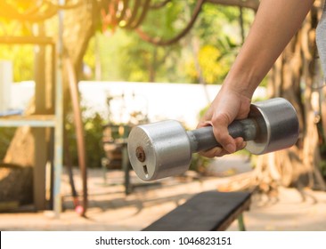 Women Hand And Dumbell In Nature Background