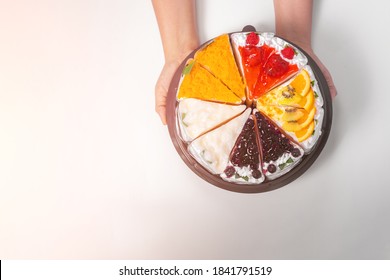 Women Hand Holding Birthday Cake On White Background. Top View