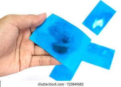 Women hand holding blue Oil absorbing blotting sheets to remove excess oil on oily face  on white background.