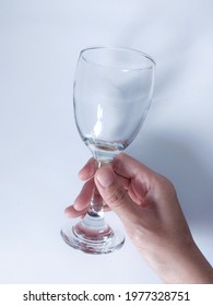 Women Hand Holding An Empty Wine Glass. Isolated Background