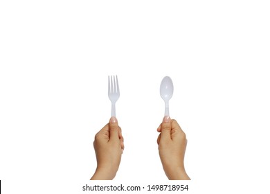 Women Hand Holding Plastic Fork And Spoon Isolated On White Background.