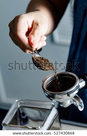 women hand making coffee in coffee machine