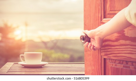 Women Hand Open Door Knob Or Opening The Door View Coffee Espresso On Wood Table Nature Background In Garden,warm Tone