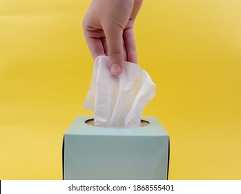 Women hand picking white napkin. white tissue paper from the blue tissue box - Shutterstock ID 1868555401