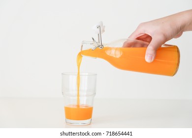 Women Hand Pouring Orange Juice