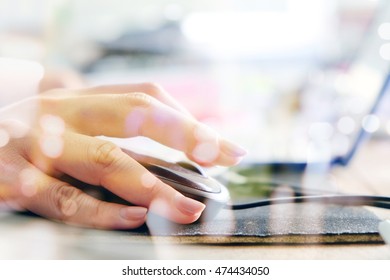 women hand using computer mouse double exposure and blurred view of car on street at night , Computer networking