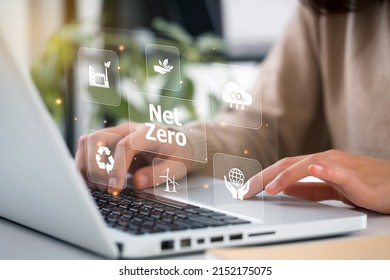 Women Hand Using Laptop For Working Technology And Business 
Net Zero And Carbon Neutral Concept.NET ZERO Icons And Symbols Save The Eco World And Reduce Pollution. Greenhouse Gas Emissions Target. 