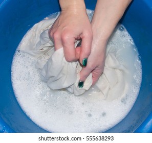 Women Hand Wash Clothes In Soapy Water.