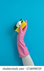 Women Hand Wearing Glove Holding Sponge With Soap For Cleaning On Blue Back Ground