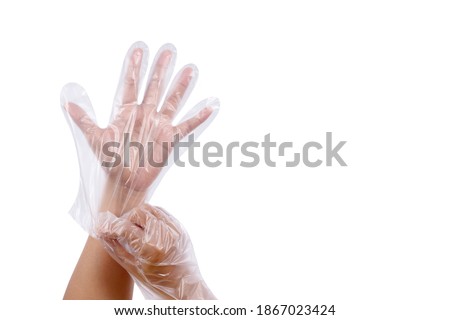 Women hand wearing plastic gloves, Multipurpose disposable gloves, Sanitary food contact gloves isolated on white background. The concept is Smart way to protect hands 