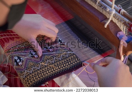 Women hand weave traditional fabrics and textiles technique locally with unique craftsmanship and the famous sarong popular product as a souvenir in Mae Chaem District, Chiang Mai, Northern Thailand.