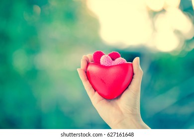 Women Hands Hold A Red Hearts On Vintage And Retro Background, For Supporting When People Get Who Lack Of Desire With Love Concept.