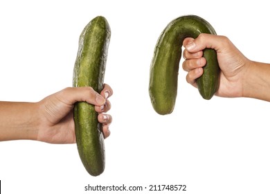 women hands holding distorted and normal cucumber on white background