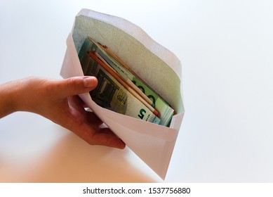 Women Hands holding white envelope full of money - Shutterstock ID 1537756880