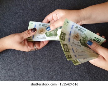 Women Hands Paying And Receiving Mexican Money