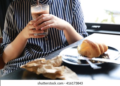  Women Have Breakfast With Use Phone , Croissant ,hand Hold Ice Coffee Glass And Eating Breakfast