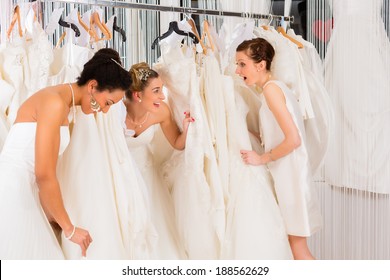 Women having fun during bridal gown fitting in wedding fashion store