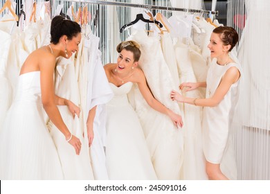 Women Having Fun During Bridal Gown Fitting In Wedding Fashion Store