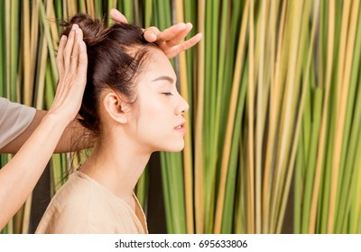 Women Is Having Head Massage Relaxation On Tree Background In A Salon Spa. For Healthy Wellness Natural Lifestyle Concept.