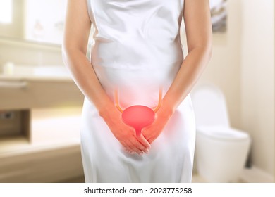 Women having urethritis and Urinary Incontinence. Female with hands holding her crotch