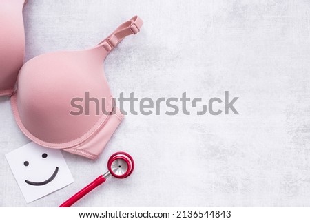 Women health and breast cancer concept with pink bra and stethoscope