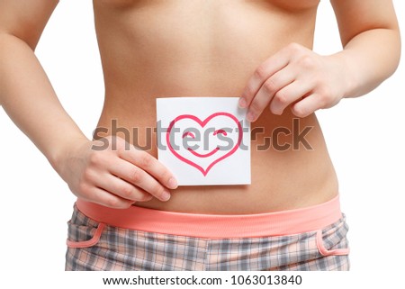 Women Health. Closeup Of Healthy Female With Beautiful Fit Slim Body Holding White Card With Happy Smiley Face heart shaped In Hands. Stomach Health And Good Digestion Concepts. High Resolution