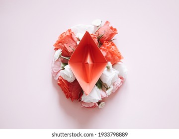 women Health. red paper boat on flower buds. abstract symbolic image of the female reproductive system