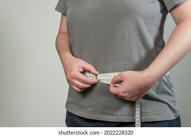 Women healthy body care weight control measuring waist fat using tape measure or measuring tape. Weight loss, healthy lifestyle concept. - Shutterstock ID 2022228320
