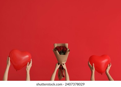 Women with heart-shaped balloons and roses on red background. Valentine's Day celebration