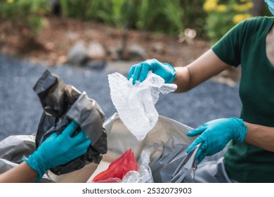 Women are helping to collect and separate garbage, focusing on plastic waste management.They sort plastic bags, glass bottles,foam,  cloth scraps, contributing to environmental conservation efforts - Powered by Shutterstock