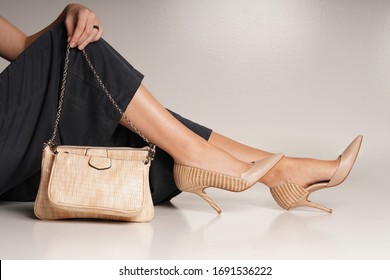 women high heel and handbag in isolated white background in the studio