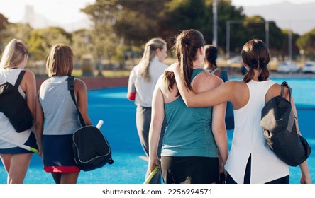 Women, hockey and teamwork on field together with support, solidarity or walking to fitness training with coach. Sports group, friends and walk from workout, outdoor exercise or hug with conversation - Powered by Shutterstock